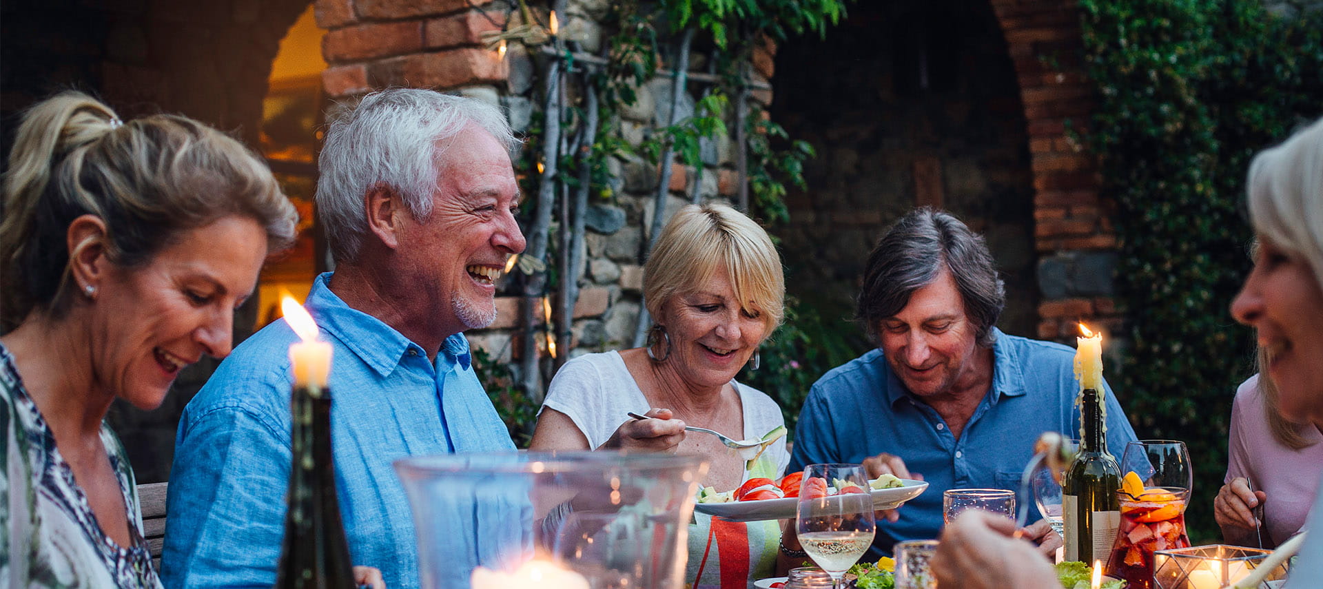 Group of mature friends eating outside
